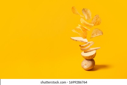 Flying potato slice into potato chips isolated on yellow background