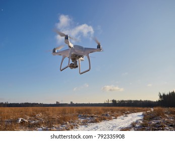 flying quadcopter with camera in the sky. winter, snow