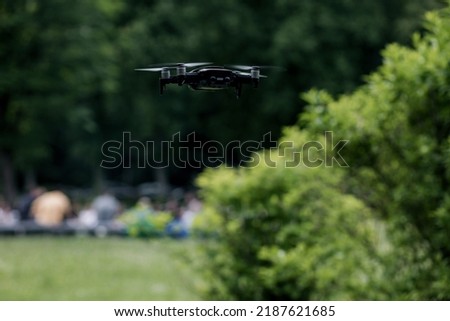 Flying quadrocopter on a green background. Aerial Drone