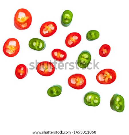 Flying Red chili pepper. Slices of Cayenne pepper isolated on white background, close up