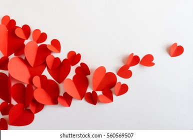 Flying red paper hearts on white background. Valentine's Day. Symbol of love. Copy space.