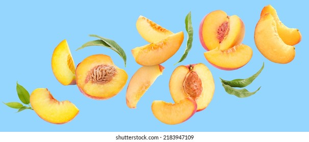 Flying Ripe Cut Peaches On Blue Background