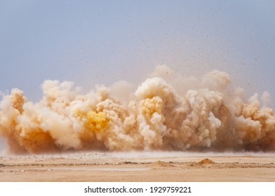Flying rock particles and dust storm during dynamite blast on the construction site 