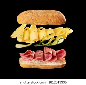 flying sandwich layers baked ciabatta bun, thinly sliced beef sausage, edam cheese and cucumbers, black background