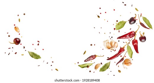 Flying set of colorful spices peppers, chili, garlic, laurel leaf, herbs in the air isolated on white background. Food and cuisine ingredients wide banner, top view, with copy space. 