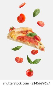 flying slice of margherita pizza with tomatoes and basil - Shutterstock ID 2145699657