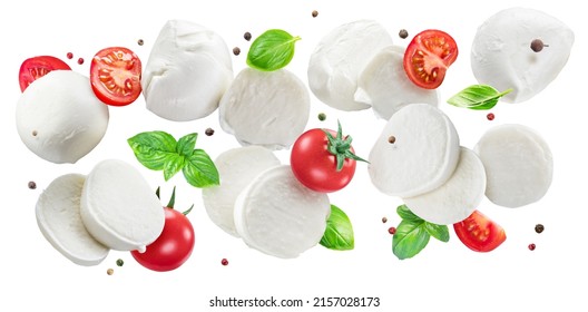 Flying slices of mozzarella cheese with cherry tomatoes, pepper and basil isolated on white background. The concept of organic food products for Mediterranean cuisine caprese salad. Clipping path.