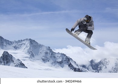 Flying Snowboarder On Mountains. Extreme Winter Sport