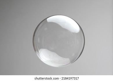 Flying soap bubbles on grey background. Abstract soap bubbles with reflections. Soap bubbles in motion background.