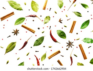 Flying spices Bay leaf, red chili pepper, anise, cinnamon sticks isolated on a white background. pattern.