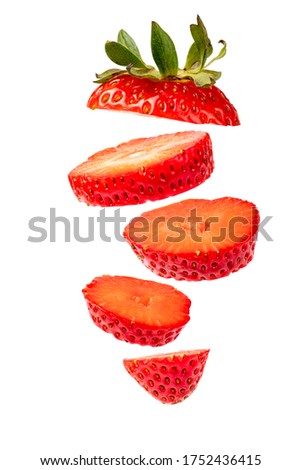 Flying Strawberry isolated on a white background. Levitating Sliced berry. Clipping path for design.