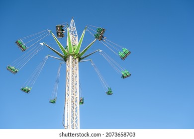 Flying swing carousel in action with empty seats at an amusement park