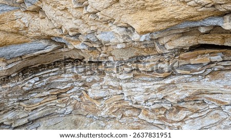Flysch is a sequence of sedimentary rock layers that progress from deep water and turbidity flow deposits to shallow water shales and sandstones creating colorful strata