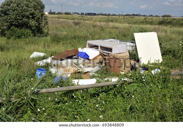 Fly-tipped household furniture, clearance\
and industrial waste dumped in the\
countryside.