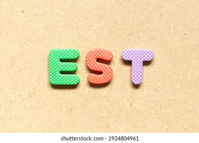 Foam Alphabet Letter In Word EST (abbreviation Of Established, Estimated, Eastern Time Zone, Expressed Sequence Tag) On Wood Background