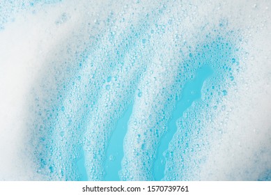 Foam Bubble Wipe Cleaning Washing  On Blue Background On Top View Texture Art Abstract