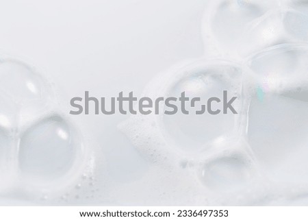 Foam bubbles background. Soap foam bubble, white backdrop. Soap sud macro structure. Bath. Soap foam close-up. Clean, cleaning concept, laundry, shower gel, shampoo