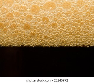 Foam From Dark Beer With Bubbles