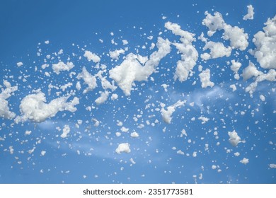 Foam party, foam cannon against the blue sky.Soap foam flies from a cannon against the sky.