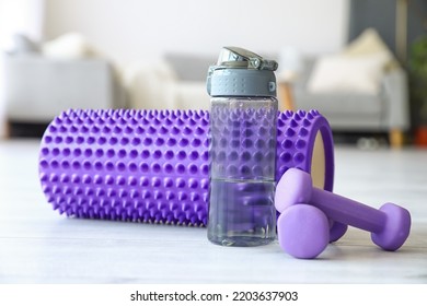 Foam Roller With Bottle Of Water And Dumbbells In Living Room