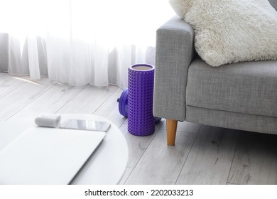 Foam Roller And Dumbbell Near Sofa In Living Room