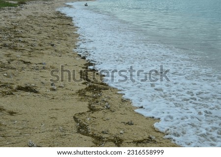 foam sea waves and white sand beach background, beach atmosphere in the morning.