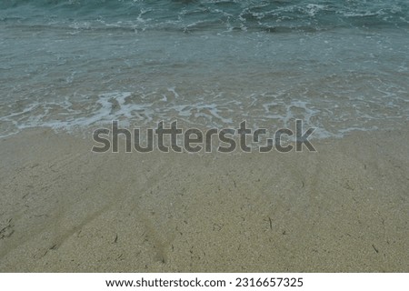 foam sea waves and white sand beach background, beach atmosphere in the morning.
