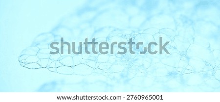 Foam structure closeup, Foam texture design on blue background. Liquid soap bubbles, cells. Foam border, backdrop. Photo of soap sud macro structure. Soap foam close-up. Clean, cleaning, washing
