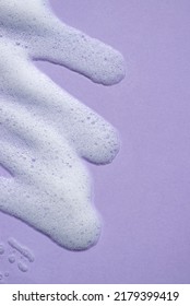 Foam Swatch On A Lilac Background. Soapy Liquid Texture With Bubbles. Natural Sunshine And Shadows. Skin Care Cleansing Cosmetic In Top View.