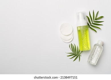 Foaming Facial Cleanser And Micellar Water On Color Background, Top View.