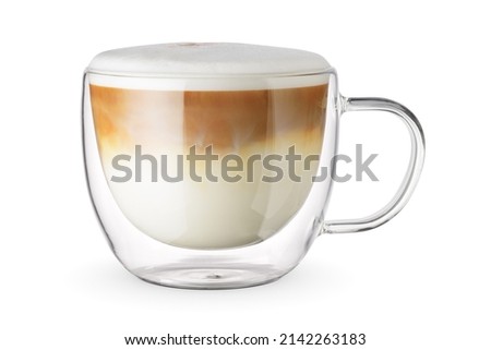 Foamy latte coffee and milk drink in a transparent double wall glass cup isolated on white background.