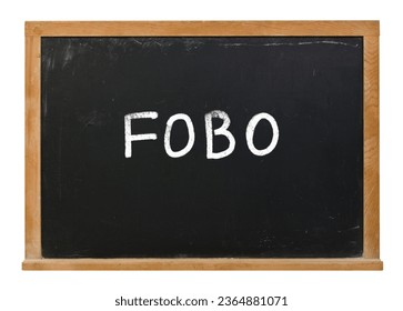 FOBO written in white chalk on a black chalkboard isolated on white - Shutterstock ID 2364881071