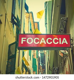 Focaccia Sign In The Street In Genoa, Italy. Focaccia Is A Flat Oven-baked Italian Bread Product, Street Fast Food. Social Media Vintage Style Filtered