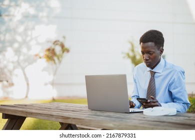 Focus African Man Working Outdoors At A Picnic Table In The Park