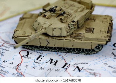 In Focus Armored Tank On Top Of Blurry Yemen Map.