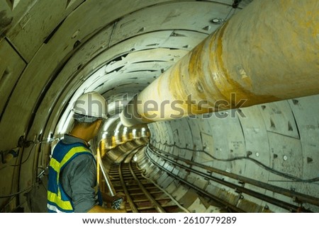  Focus at engineer or technician control. Underground tunnel infrastructure. Transport pipeline by Tunnel Boring Machine for electric train subway. Rail way with Ventilation pipe.
