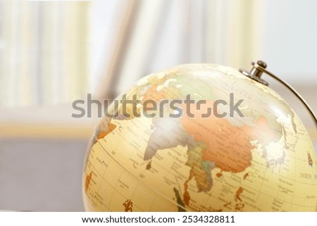 Focus globe and blur bookshelf behind.  Learning, study, knowledge and education concept.