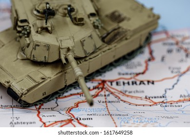 In Focus M1 Abrams Armored Tank On Top Of Blurry Iran Map.