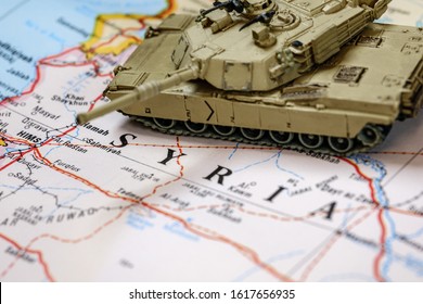 In focus M1 Abrams armored tank on top of blurry Syria map.