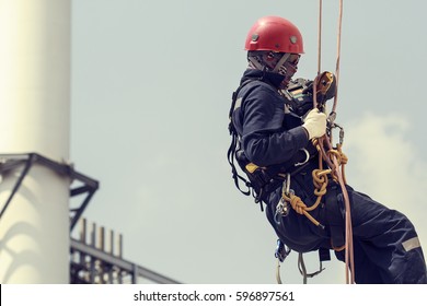 Focus Male Worker Using Rope Access Of Inspection Storage Tank