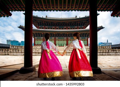 Focus at the old building, Korean lady in Hanbok or Korea gress and walk in an ancient town and Gyeongbokgung Palace in seoul, Seoul city, South Korea.