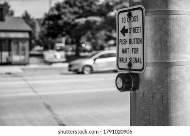 Focus On Activation Button At A Cross Walk At The Level Of The Button With Busy Traffic In The Background