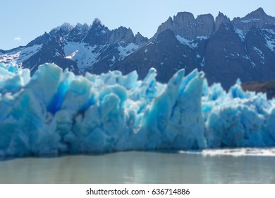 Focus on the Andes mountain range in Chile with a blurred grey glacier in the Torres del Paine national park, Patagonia.