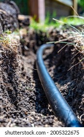 Focus On A Black 1 Inch Sprinkler Plastic Water Line Laid In A Shallow Trench