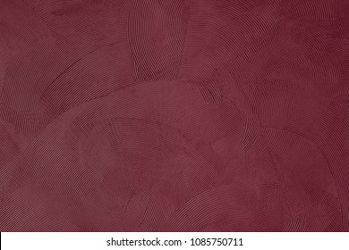 Focus on a burgundy colored wall with wave shapes