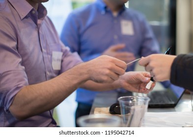 Focus on Businessman in Purple Shirt Receiving a Business Card. Business Meeting Coordinator. Seminar Check-In with Host. Event Planner. Investor Presentation Manager Accepting Attendee. Registration. - Powered by Shutterstock