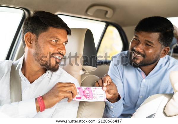 Focus on cab driver passenger or businessman\
paying money to cab driver for trip - concept of destination,\
successful journey and self\
employment