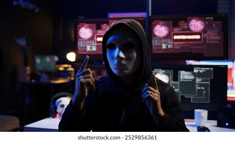 Focus on camera on phone on tripod used by hacker concealing identity filming ransom video in hidden base. Close up of smartphone used by cybercriminal with mask to record blackmail footage, camera B - Powered by Shutterstock