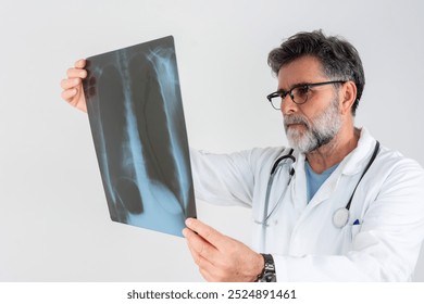 Focus on chest X-ray examination studied by multiracial healthcare practitioner. Male radiologist identifying mass in left lung using technologies. - Powered by Shutterstock