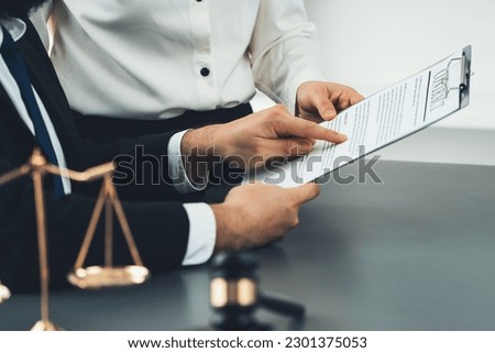 Focus on contract paper with legal team or lawyer colleagues drafting or discussing on legal documents in law firm office. Ethical and lawful resolution for clients disputes. Equilibrium